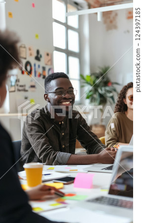 Diverse group of young professionals focused on brainstorming and collaboration in creative office space, working together on laptops, demonstrating teamwork and innovation Diverse group of young professionals focused on brainstorming and collaboration in creative office space, working together on laptops, demonstrating teamwork and innovation 124397185