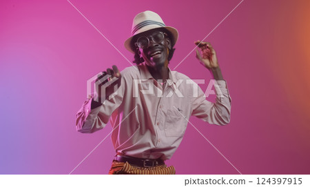A stylish person, wearing a straw hat and striped pants, dances joyfully against a pink and orange gradient backdrop. Their energy and fashion reflect carefree fun A stylish person, wearing a straw hat and striped pants, dances joyfully against a pink and orange gradient backdrop. Their energy and fashion reflect carefree fun 124397915