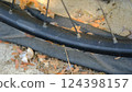 A bicycle tire that is flat because it hasn't been inflated for a long time. 124398157