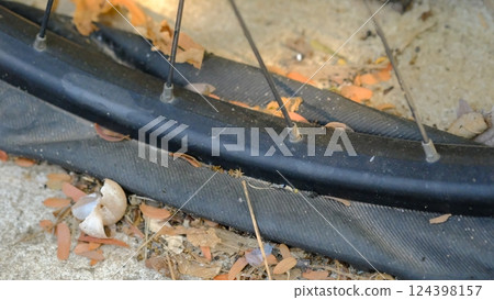 A bicycle tire that is flat because it hasn't been inflated for a long time. 124398157