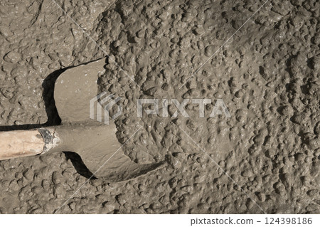 Rough cement texture background. Material wet Concrete mix stone with shovel for mixture concreting of site for car, blind area. Floor concrete. Copy space. Rough cement texture background. Material wet Concrete mix stone with shovel for mixture concreting of site for car, blind area. Floor concrete. Copy space. 124398186