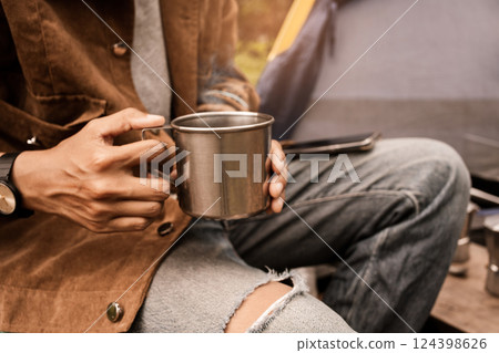 Happy asian lesbian holding hot espresso stainless steel with Italian Moka coffee pot drinking in a forest on vacation, traveler outdoor the tent happy single picnic camping on the morning Happy asian lesbian holding hot espresso stainless steel with Italian Moka coffee pot drinking in a forest on vacation, traveler outdoor the tent happy single picnic camping on the morning 124398626