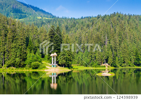 lake among spruce forest. amazing carpathian travel destination. green trees reflecting on the calm water surface. wonderful summer scenery on a bright sunny day lake among spruce forest. amazing carpathian travel destination. green trees reflecting on the calm water surface. wonderful summer scenery on a bright sunny day 124398939