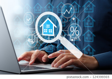 Researching real estate price trends and mortgage interest rates. Man using laptop to buy a house. 124399303