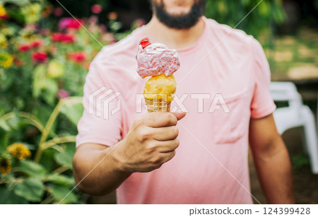 Unrecognizable people holding ice cream in cone outdoors. Front view of person hands holding an ice cream cone. People showing a double ice cream cone. Cone ball ice cream concept 124399428