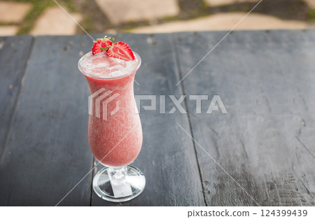 Strawberry smoothie on wooden table. Strawberry milkshake on wooden table with blurred background. Close up of healthy strawberry smoothie on wood with blurred background Strawberry smoothie on wooden table. Strawberry milkshake on wooden table with blurred background. Close up of healthy strawberry smoothie on wood with blurred background 124399439