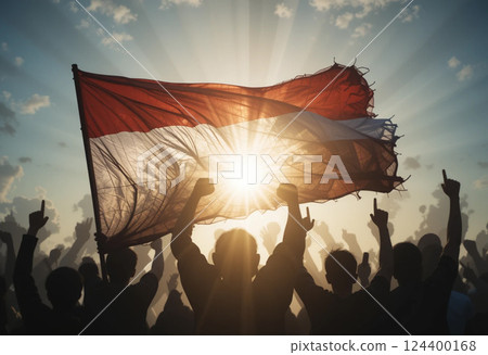 indonesia flag waving with silhouette of people with fists up 124400168