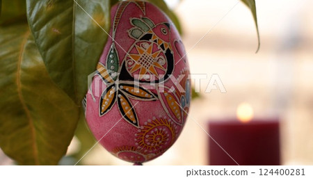 Easter decorations featuring handcrafted Easter egg dot art pysanka with vibrant colors and intricate designs displayed against a warm background Easter decorations featuring handcrafted Easter egg dot art pysanka with vibrant colors and intricate designs displayed against a warm background 124400281