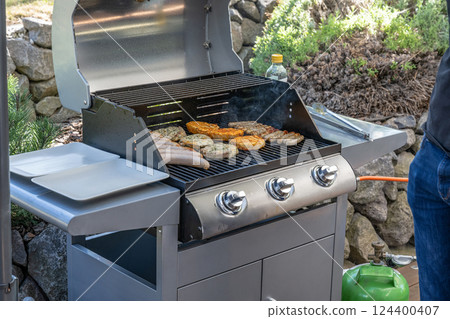 Barbecue grill bbq on propane gas grill steaks bratwurst sausages meat meal 124400407