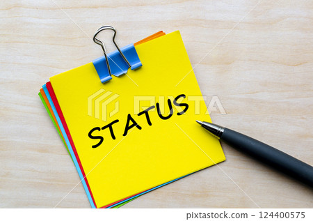 Status text on yellow notepad. Business Updates and status concept Status text on yellow notepad. Business Updates and status concept 124400575