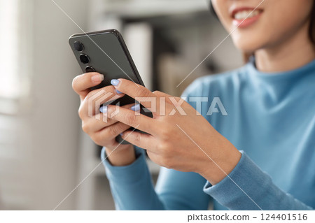 Technology and Daily Communication. A woman using her smartphone to connect with friends and family. Technology and Daily Communication. A woman using her smartphone to connect with friends and family. 124401516