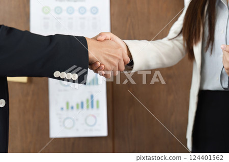 Business Agreement and Professional Interaction. Two professionals engaging in a handshake to finalize a partnership. Business Agreement and Professional Interaction. Two professionals engaging in a handshake to finalize a partnership. 124401562