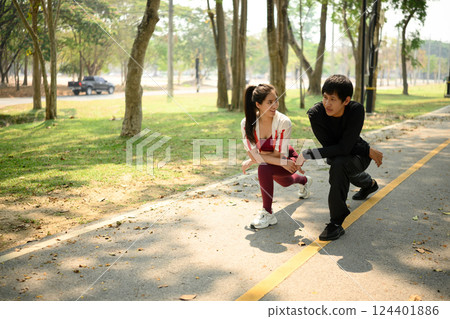 Happy young couple stretching before their jog or outdoor exercise session 124401886
