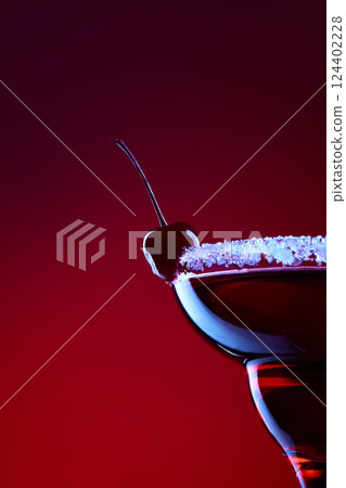 Bloody Mary. Closeup of cherry cocktail with sugar rim lit by neon red light against gradient background. Concept of night party 124402228