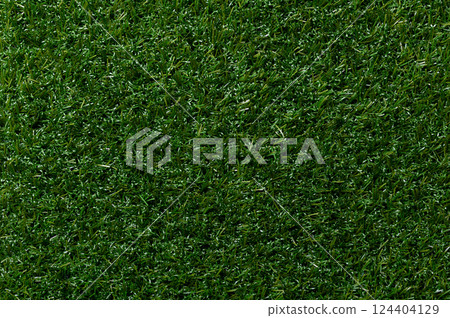 Artificial turf, plastic grass, surface and background. Green colored surface of synthetic fibers made to look like natural grass. Used in sports arenas, residential lawns and commercial applications. Artificial turf, plastic grass, surface and background. Green colored surface of synthetic fibers made to look like natural grass. Used in sports arenas, residential lawns and commercial applications. 124404129