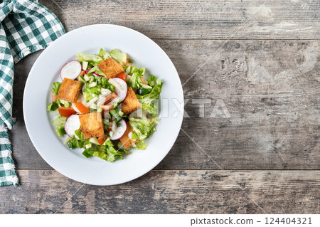 Fattoush salad, Traditional Lebanese Salad on wooden table 124404321