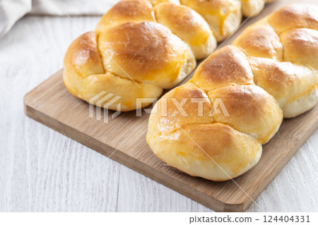 Traditional Easter braided bread. Tsoureki braid on wooden table Traditional Easter braided bread. Tsoureki braid on wooden table 124404331