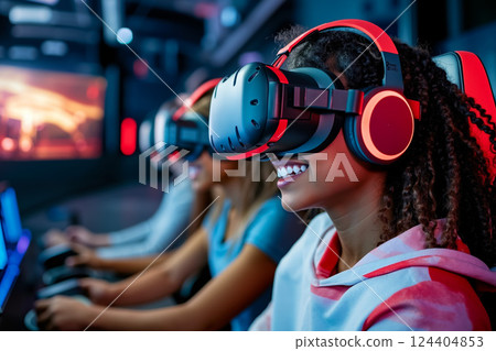A group of people wearing virtual reality headsets playing video games 124404853