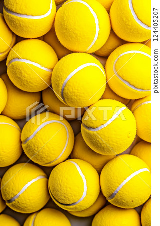 A pile of yellow tennis balls with white stripes A pile of yellow tennis balls with white stripes 124405207