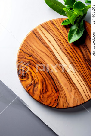 A wooden cutting board with a plant on top of it A wooden cutting board with a plant on top of it 124405208
