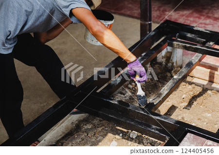 Hand painting anti rust paint on steel at home decorated. 124405456