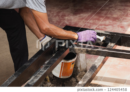 Hand painting anti rust paint on steel at home decorated. Hand painting anti rust paint on steel at home decorated. 124405458