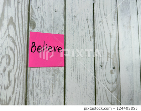 Pink sticky note with Believe written on it, placed on white wooden board. Ideal for conveying themes of belief, positivity and motivation. Perfect for concept ideas and personal growth Pink sticky note with Believe written on it, placed on white wooden board. Ideal for conveying themes of belief, positivity and motivation. Perfect for concept ideas and personal growth 124405853