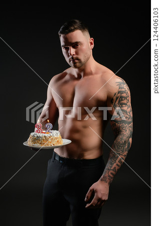 Celebrating a milestone birthday with impressive physique and cake display 124406103