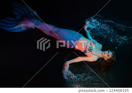 Mermaid cosplay with body art captured in a magical underwater setting 124406105