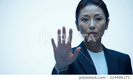 A businesswoman in a suit calling STOP 124406171