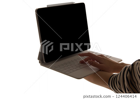 Woman typing detachable keyboard connected to tablet with dark blank screen isolated on white background. Mockup Woman typing detachable keyboard connected to tablet with dark blank screen isolated on white background. Mockup 124406414