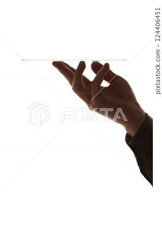 Hand holding table upside down showing its thin and modern design isolated on white background. 124406451