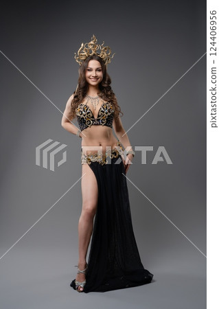 Elegant dancer showcasing traditional outfit with intricate design 124406956