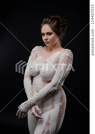 Artistic nude body painting in a studio with dark background Artistic nude body painting in a studio with dark background 124407013