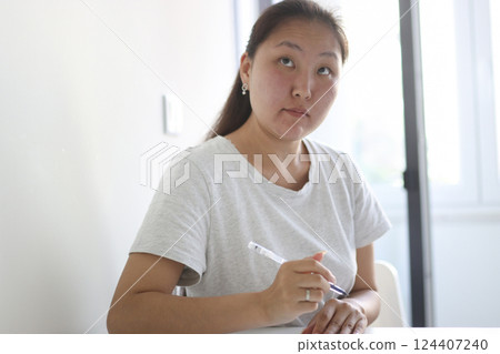 Young asian woman taking notes and brainstorming new ideas while working from home 124407240