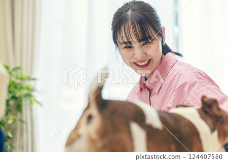 A woman who plays with a dog A woman who plays with a dog 124407580
