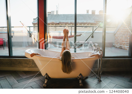 Woman feet in bathrobe at home, closeup Woman feet in bathrobe at home, closeup 124408040