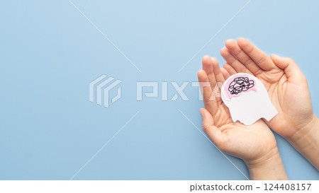 Human head with brain as tangled messy single line on blue background. Concept of mental disorder, ADHD symptom, finding solution, chaotic thinking process, confused mind. Mental health care. 124408157