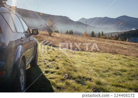 car for traveling with a mountain road 124408172