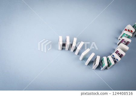 Dominoes lined up on a light background 124408516