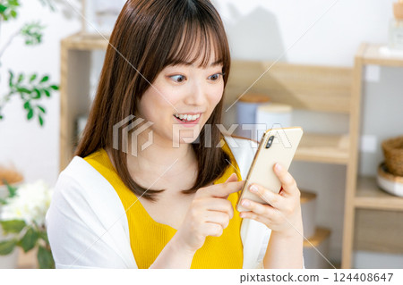 Young woman looking at a smartphone 124408647