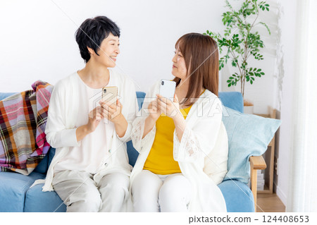 Parents and children look at smartphones 124408653