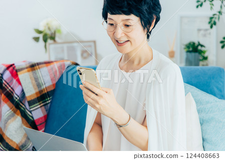 Middle woman using a computer in the living room 124408663