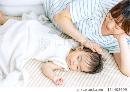 Parent and child taking a nap Parent and child taking a nap 124408699