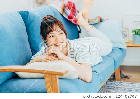 Young woman relaxing in the living room Young woman relaxing in the living room 124408708
