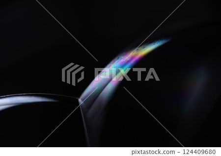 Bright liquid line on black background, phenomenal rainbow reflection, beautiful physical effects 124409680