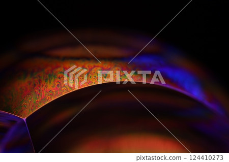 Bright orange and purple liquid surface, orange and purple fluid forms, liquid abstraction, colour surfaces, deep dark backgrounds, physical shapes 124410273