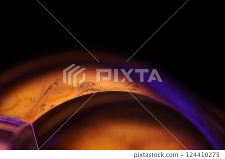 Bright orange and purple liquid surface, orange and purple fluid forms, liquid abstraction, colour surfaces, deep dark backgrounds, physical shapes 124410275