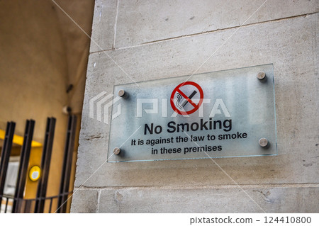 No Smoking Sign on a Wall with Legal Warning in Public Area No Smoking Sign on a Wall with Legal Warning in Public Area 124410800