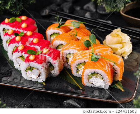 Japanese sushi platter on dark stone background 124411608